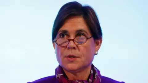 GETTY IMAGES Headshot of Baroness Kate Lampard, peering over small round glasses and wearing a pashmina.